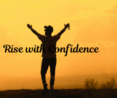 Man standing with raised hands towards sunrise, symbolizing self-confidence, empowerment, and new beginnings.